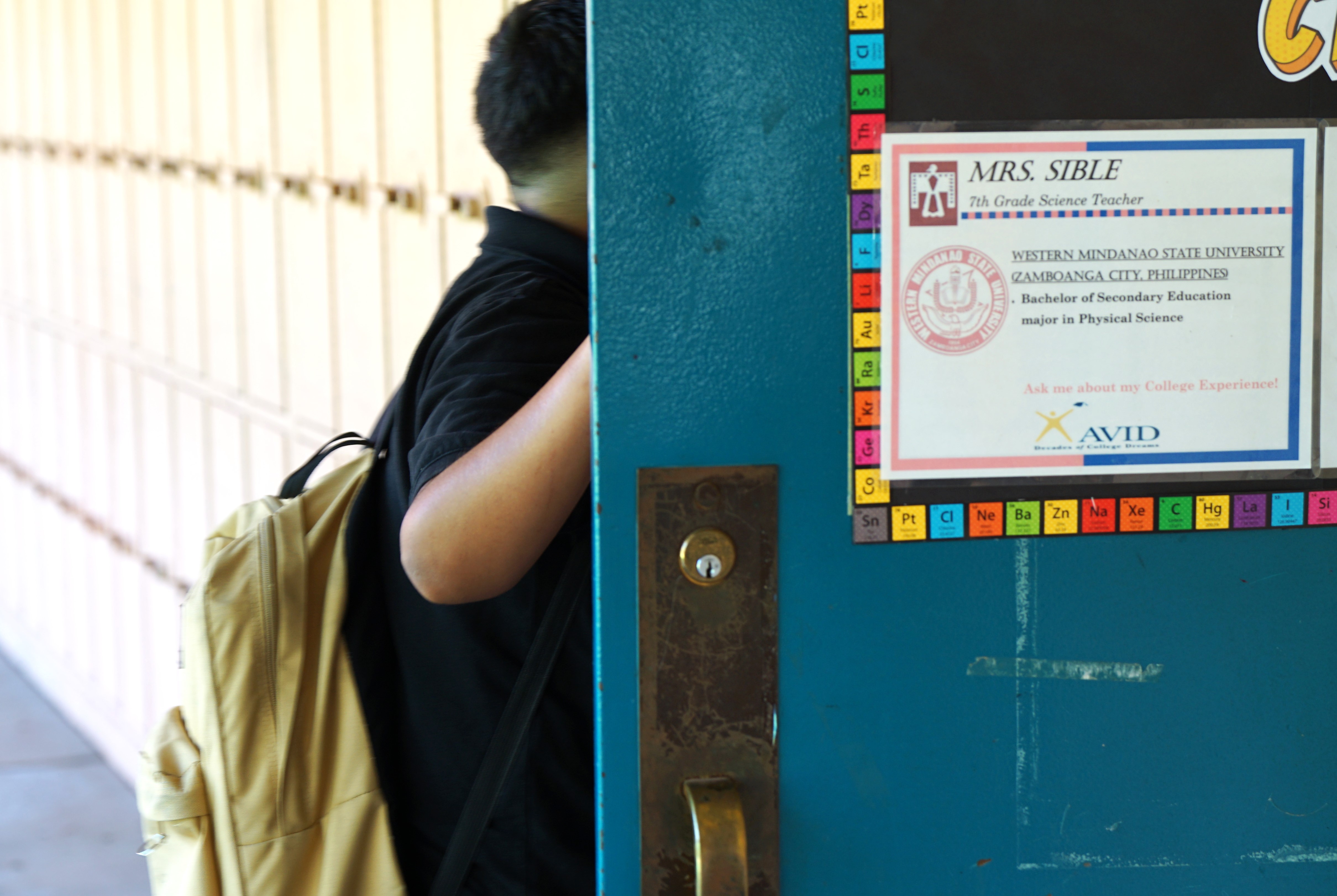 A boy walks in the door of his 7th grade classroom