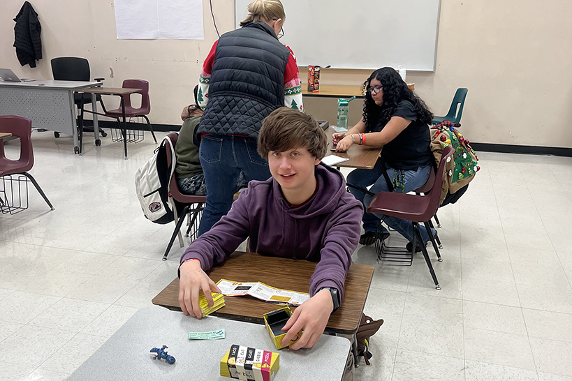 A boy looks up from a game he's playing