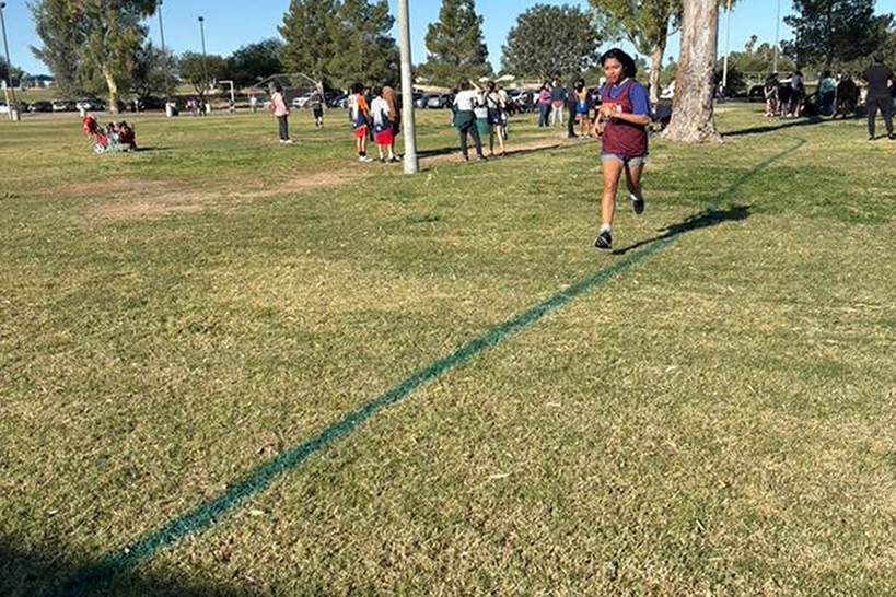 A student runs across a field